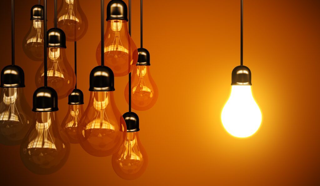 Are Your Lights Flickering? Here Are Common Electrical Issues 1 Glowing light bulb among unlit bulbs.