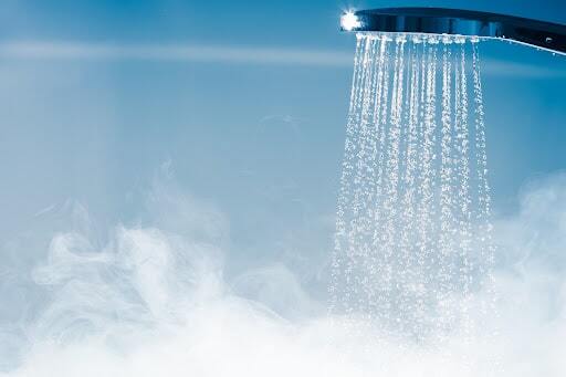 Hot shower water with steam rising.