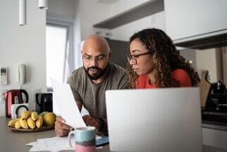 An image of a couple reviewing heating bills.