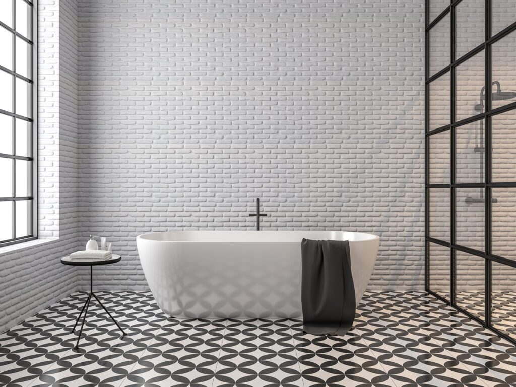 A modern bathroom with a beautiful bathtub, white-painted brick walls, and tiled floors.